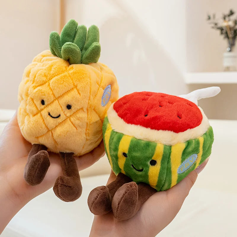 Plush kawaii toys shaped like a pineapple and watermelon held in a hand with a blurred background.