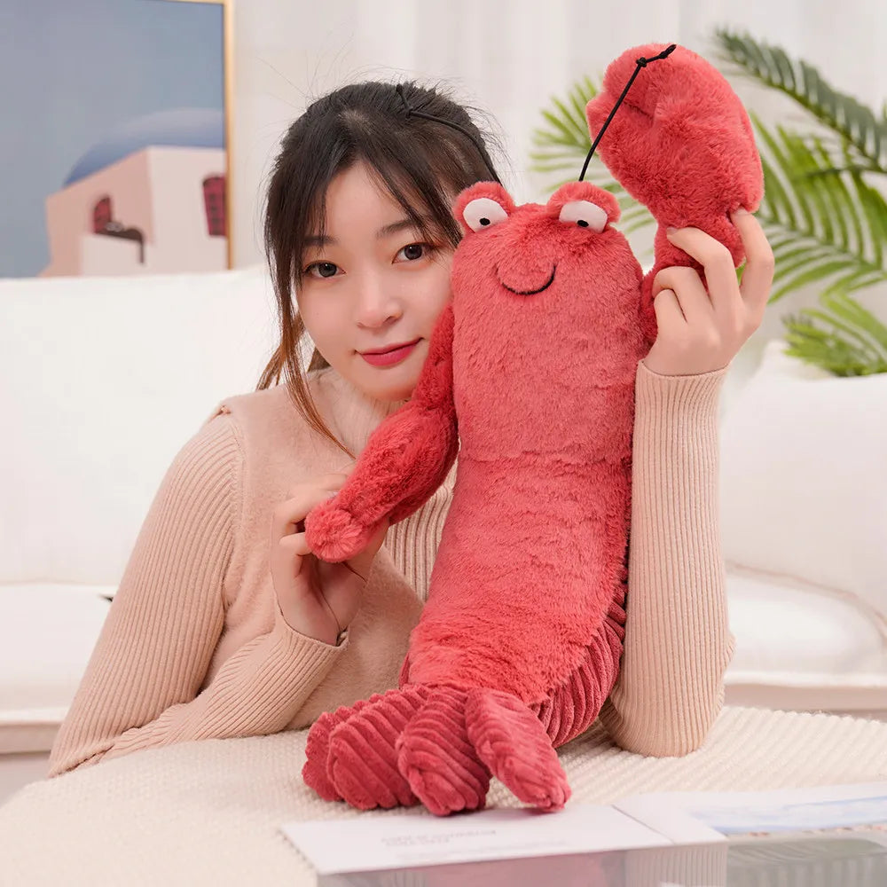 Person holding a red kawaii plush lobster toy indoors