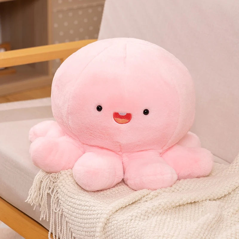 Pink kawaii plush octopus toy on a chair with a neutral background