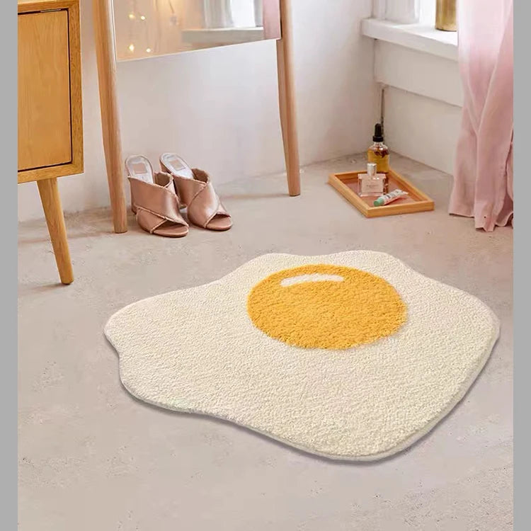 Fried egg-shaped kawaii rug on a light gray floor with a wooden cabinet and mirror in the background.