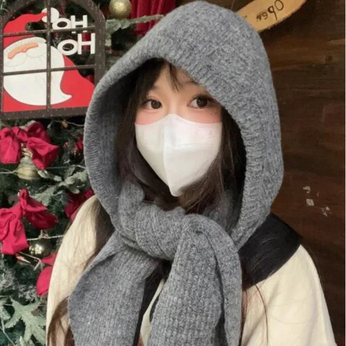 Person wearing a Kawaii gray hooded scarf with a blurred background