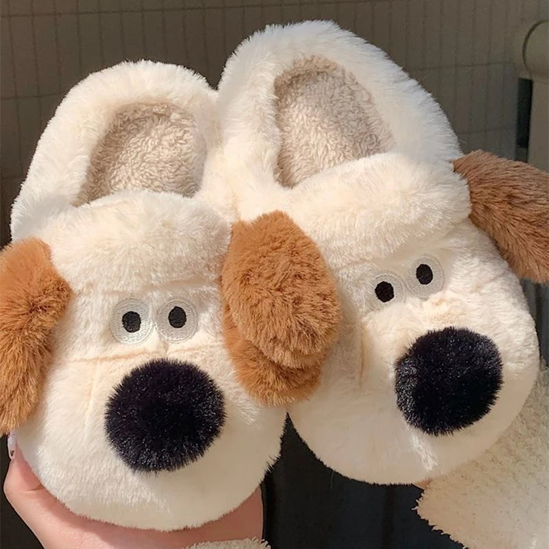 Pair of plush dog kawaii slippers held by a person.