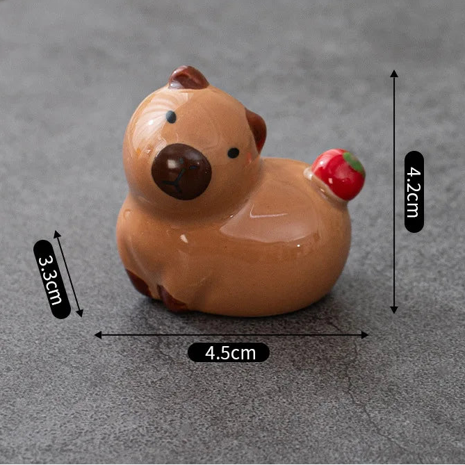 Small brown kawaii animal figurine with measurements on a gray background