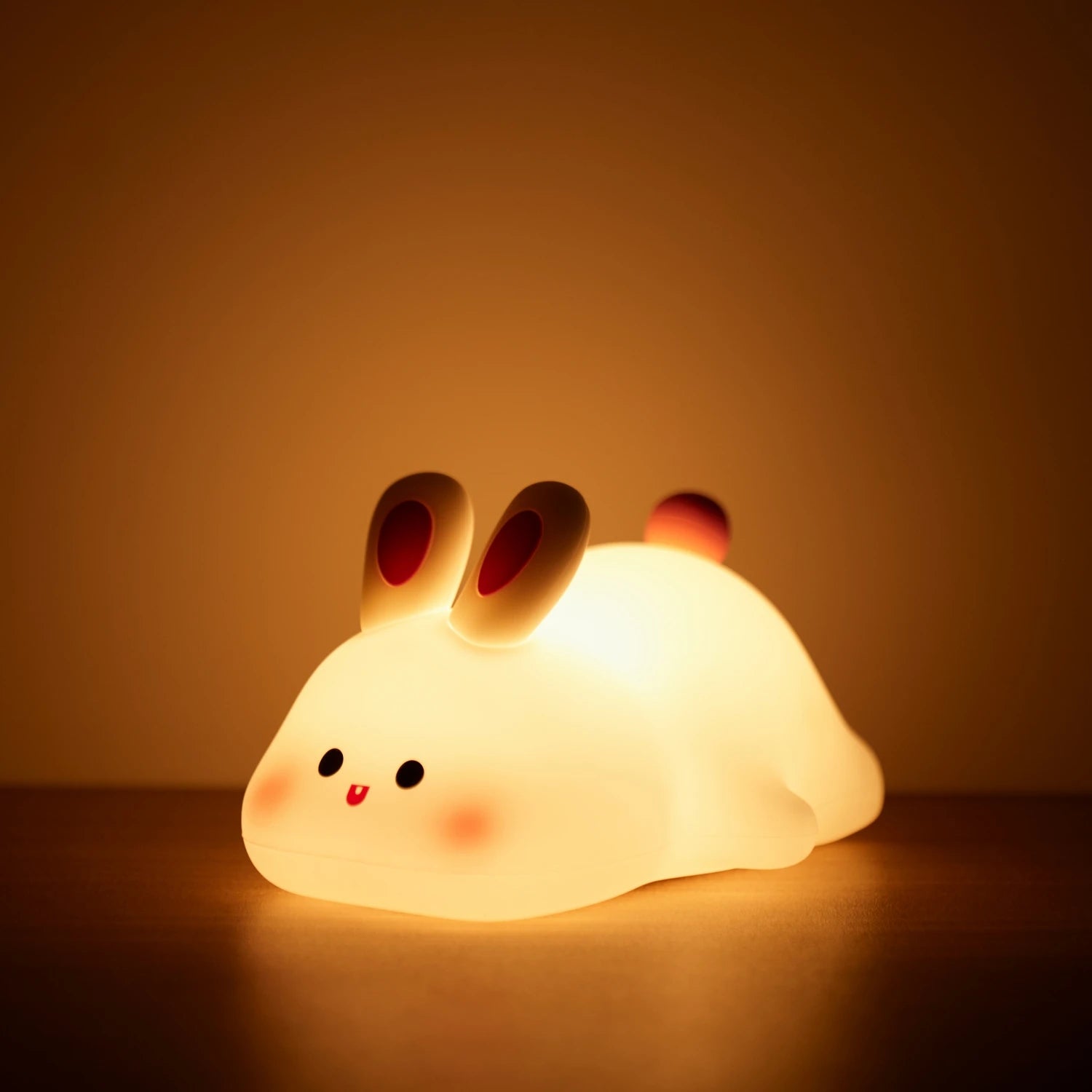 Cute kawaii rabbit-shaped night light on a dark background