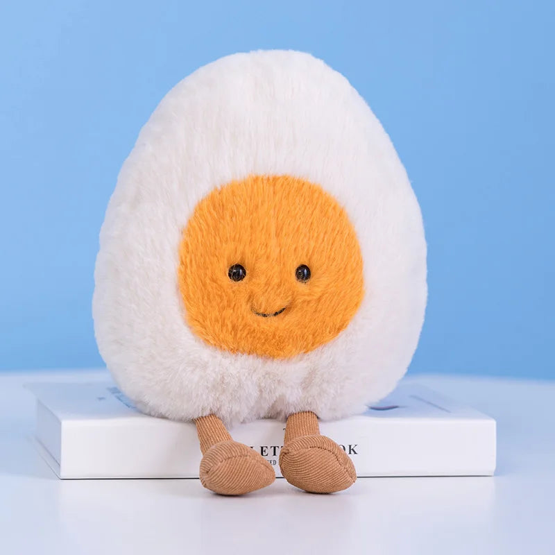 Plush kawaii toy resembling a boiled egg with a smiling face on a blue background