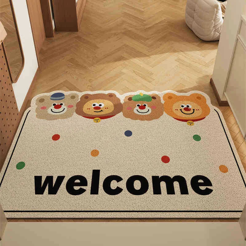 Beige doormat with Kawaii cartoon bear faces and 'welcome' text on a wooden floor.