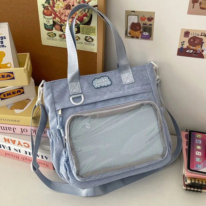 Blue Kawaii bag on a surface with books and magazines in the background