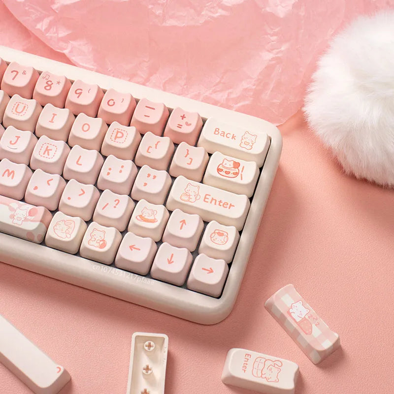 Pink and white keyboard with Kawaii cartoon character keys on a pink surface