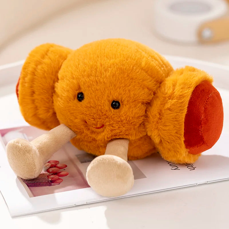 Plush kawaii elephant toy on a magazine with a blurred background