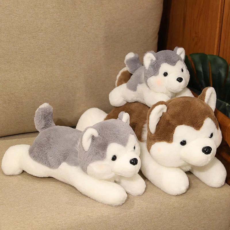 Three plush husky kawaii toys on a beige couch.