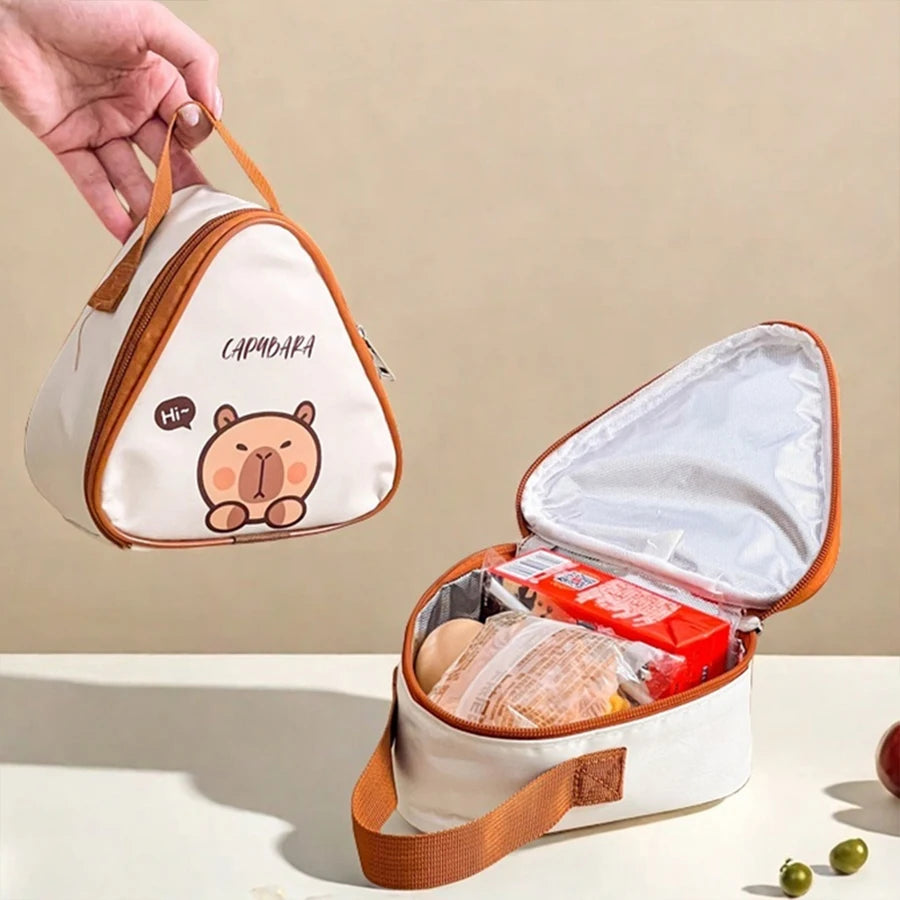Triangular lunch bag with kawaii cartoon bear design, open to reveal food items on a beige background