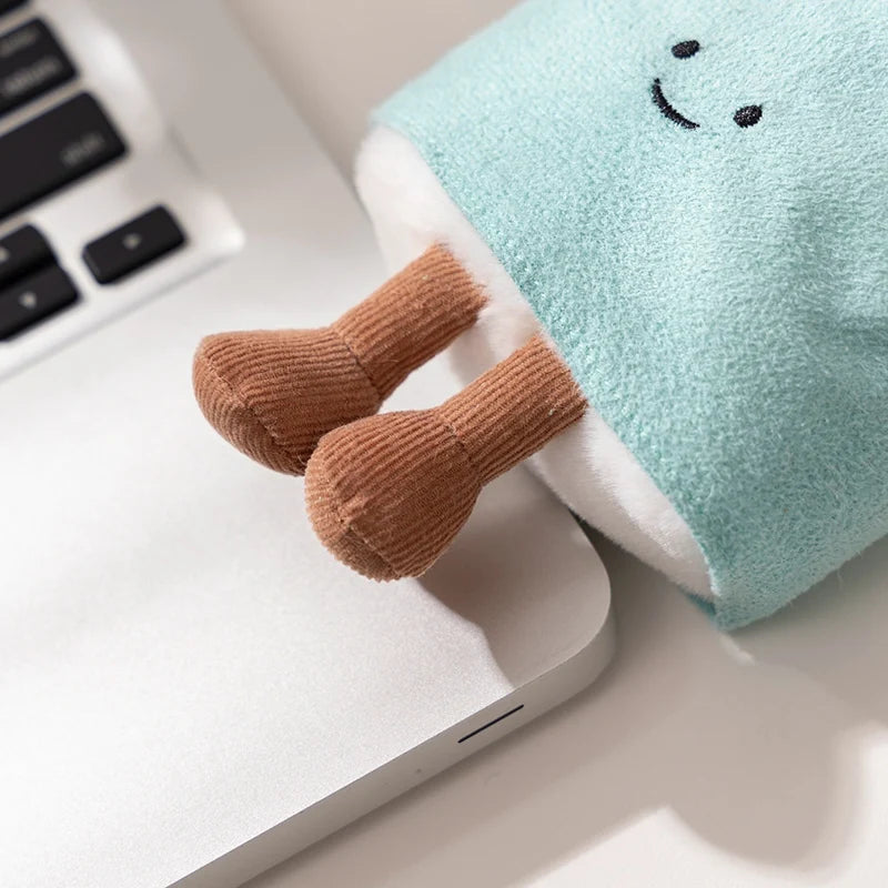 Kawaii plush toy with a smiley face on a laptop