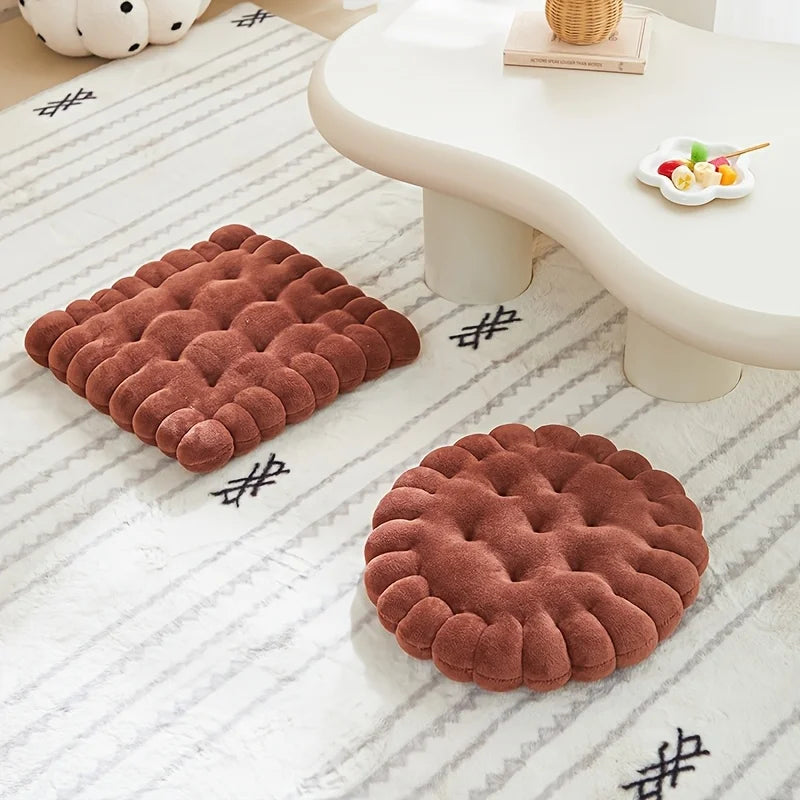 Two brown textured kawaii cushions on a white floor with a light-colored table in the background.