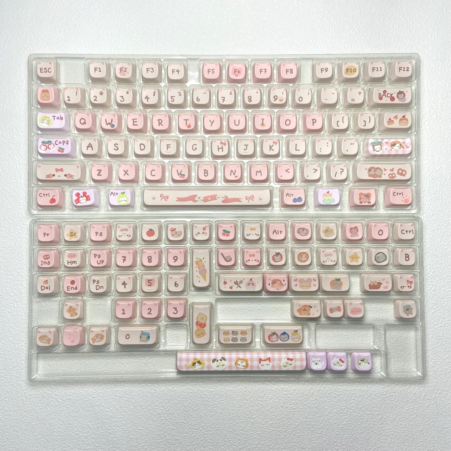 Kawaii keyboard with pink and clear keycaps on a white background