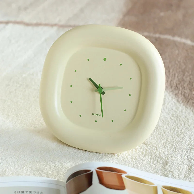 Round kawaii clock with green hands on a textured surface