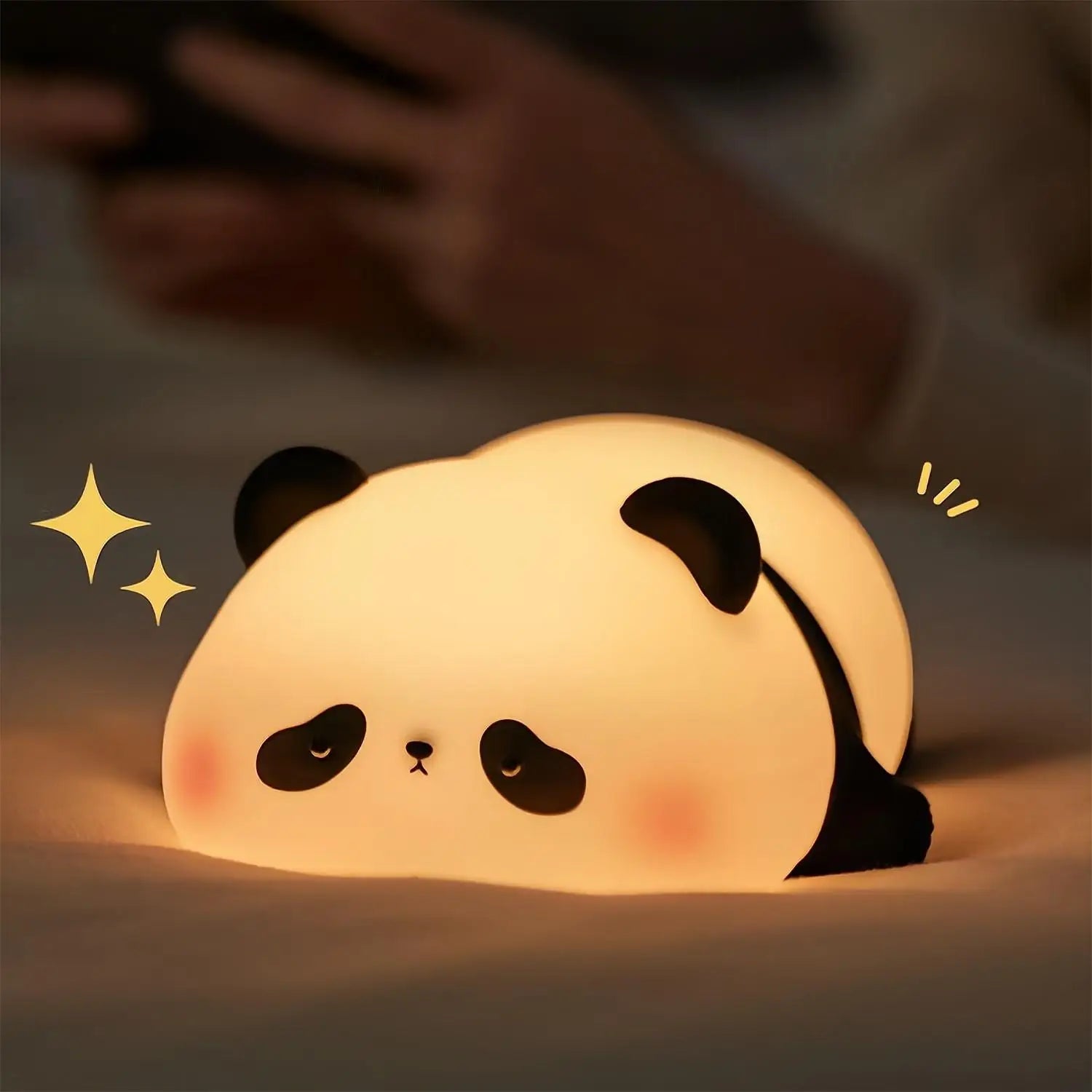 Cute kawaii panda-shaped night light on a soft surface with a blurred background