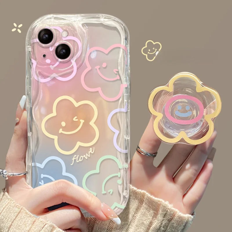 Clear phone case with colorful cloud kawaii designs held by a person