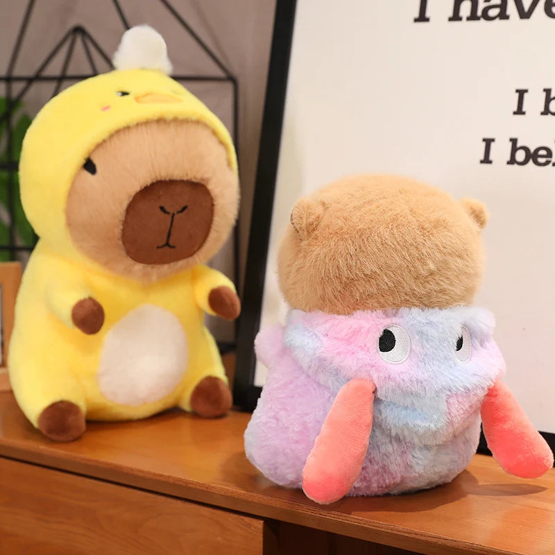 Two kawaii plush toys, one in a yellow dinosaur costume and the other in a multicolored outfit, on a wooden surface.