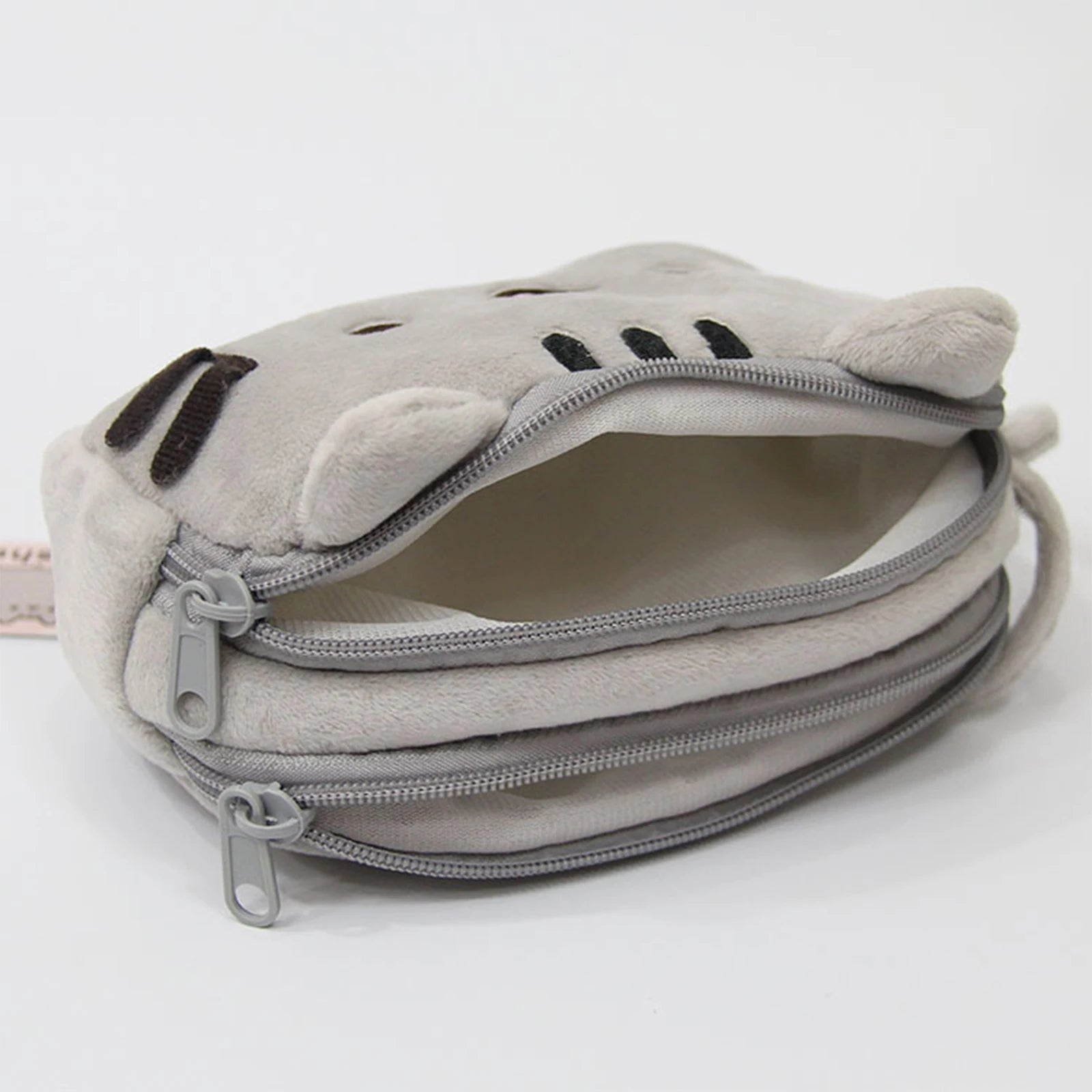 Gray pouch with kawaii cat ears and face design on a white background