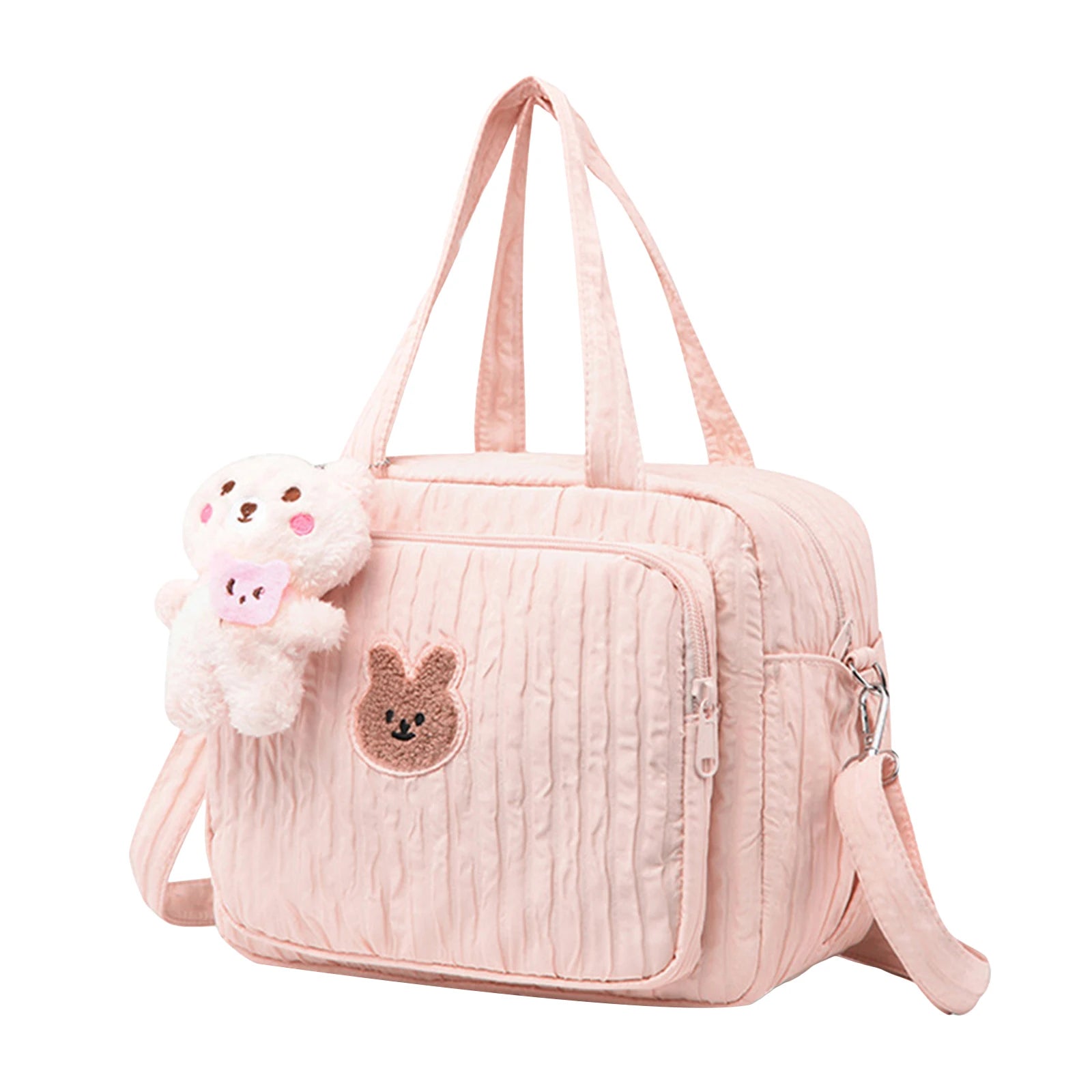 Pink diaper bag with Kawaii bear emblem and plush toy on a white background