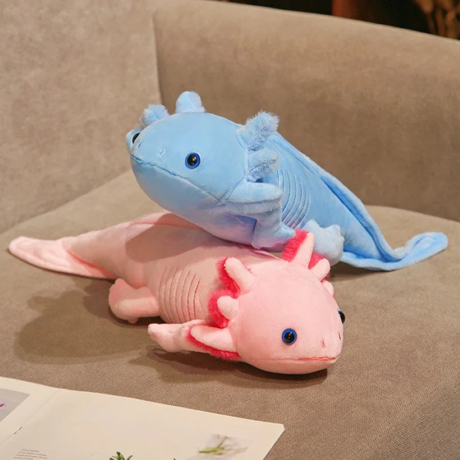 Two axolotl kawaii plush toys, one blue and one pink, on a brown surface.