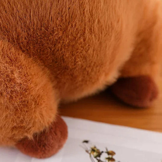Close-up of a brown kawaii teddy bear on a white surface with a wooden background