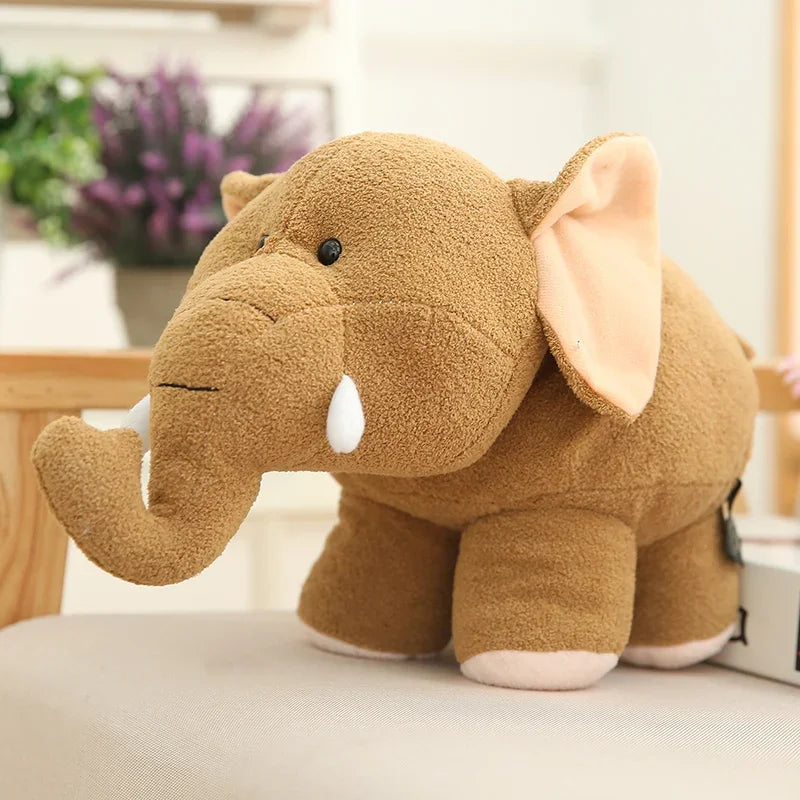 Brown kawaii plush elephant toy on a light surface with a blurred indoor background