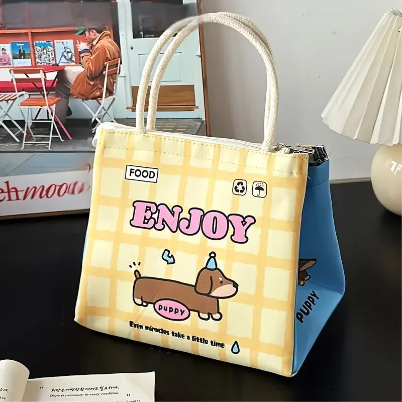 Tote bag with 'ENJOY' and kawaii dog illustration on a table