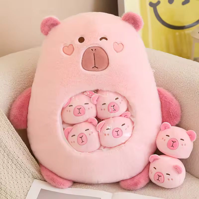 Pink bear-shaped kawaii plush toy with smaller bear plushies inside, on a beige surface.