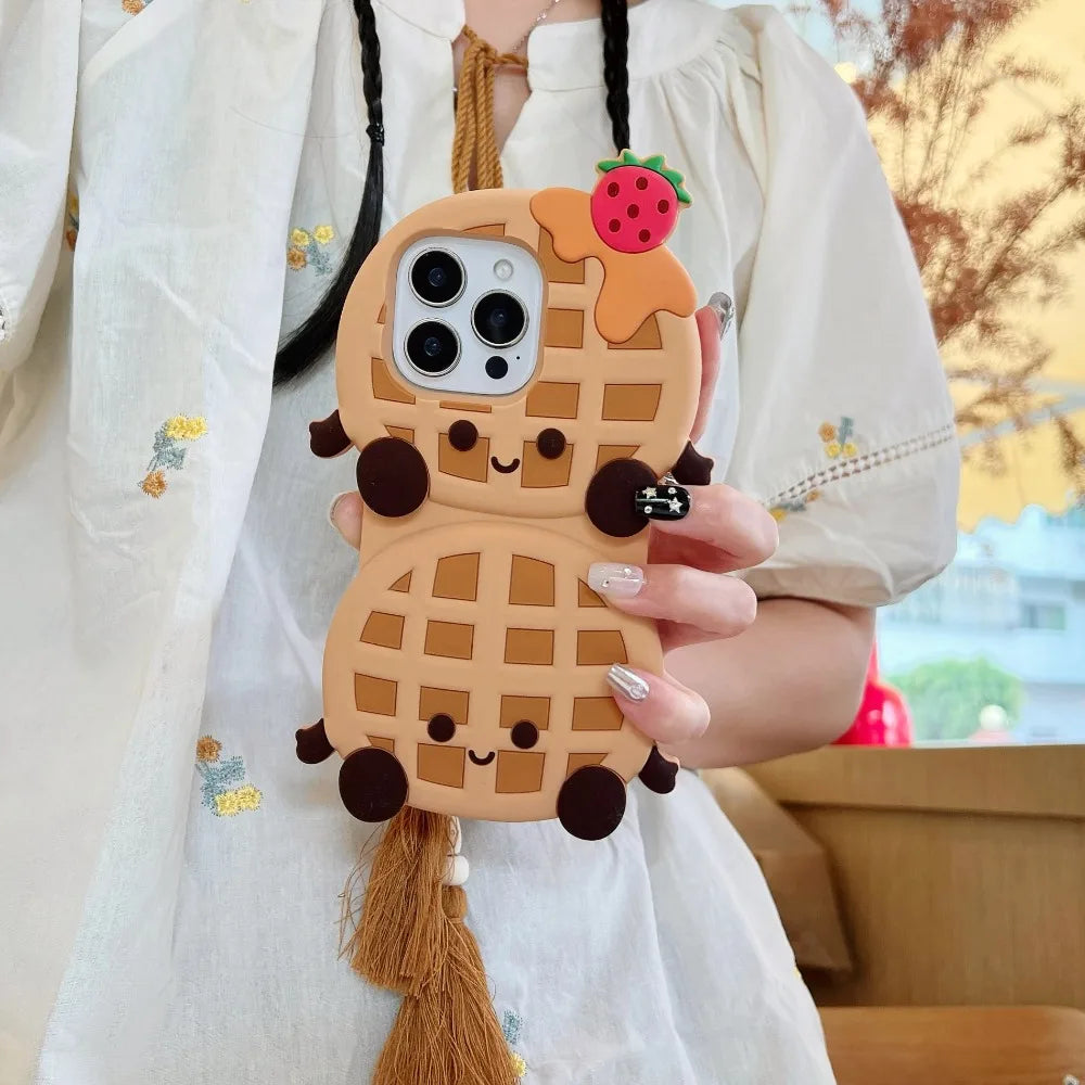 Person holding a kawaii phone case shaped like a waffle with a strawberry on top.