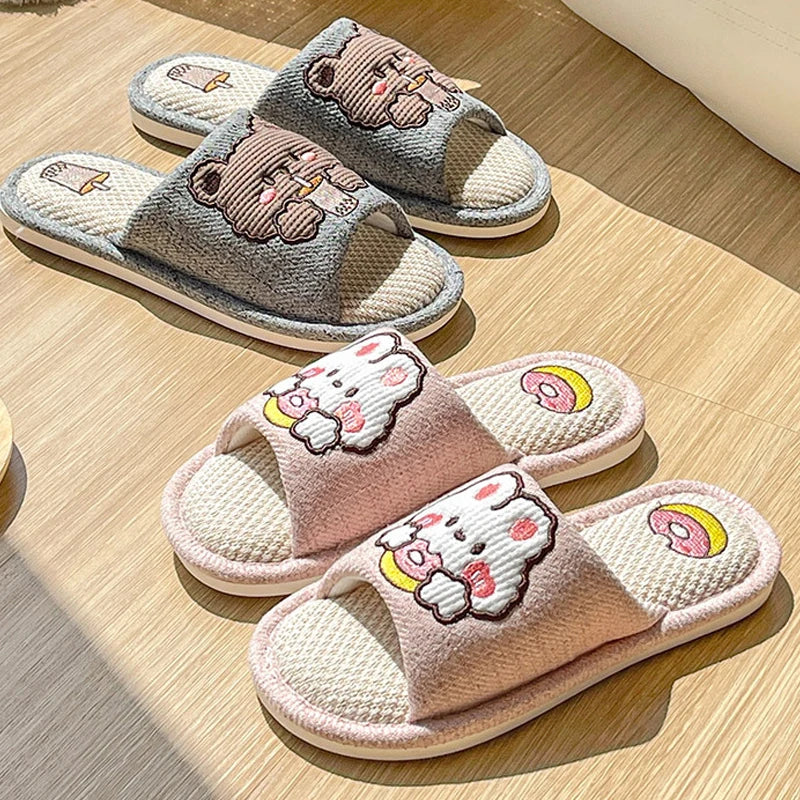 Pair of kawaii cartoon-themed slippers on a wooden floor