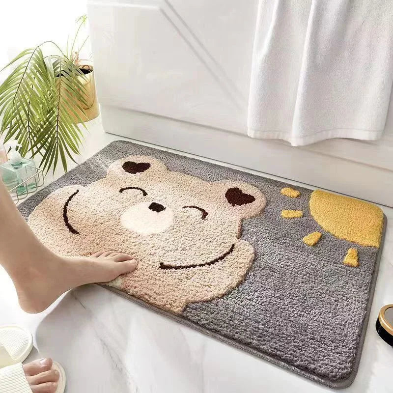 Cartoon Kawaii bear face bath mat with a foot stepping onto it, in a bathroom setting.