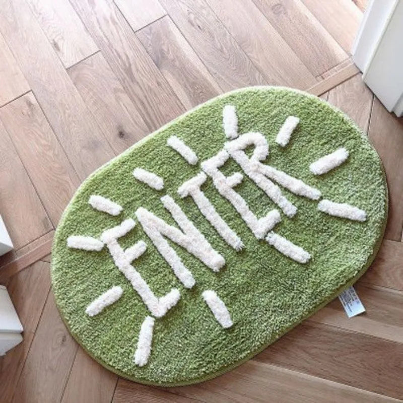 Kawaii green rug with 'Enter' text on a wooden floor