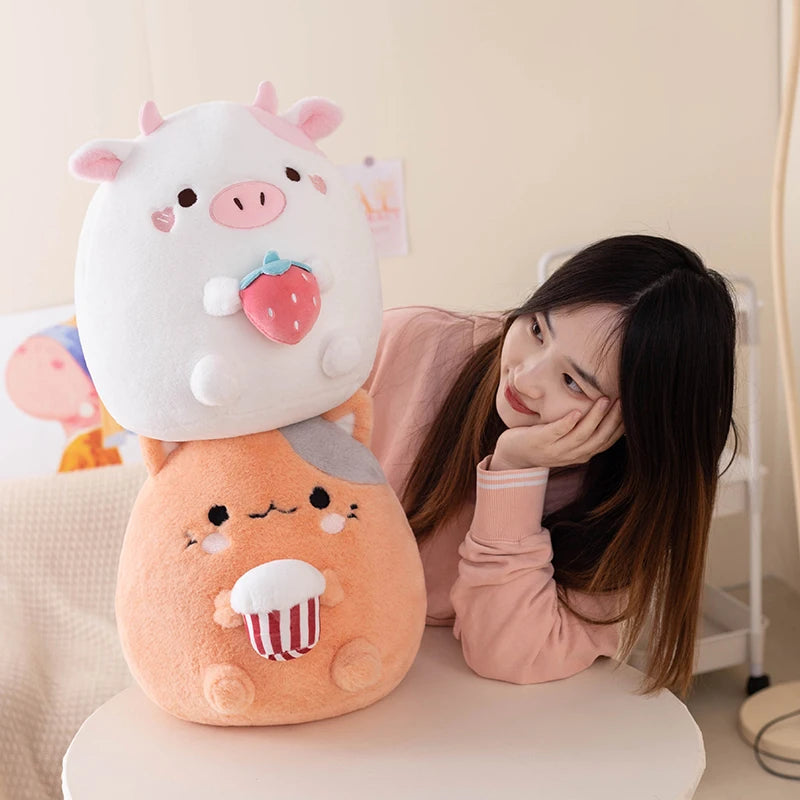 Person sitting with a large, cute kawaii plush toy on a chair