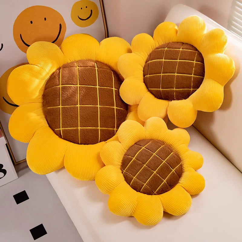 Sunflower-shaped kawaii cushions with a checkered center on a light-colored surface.
