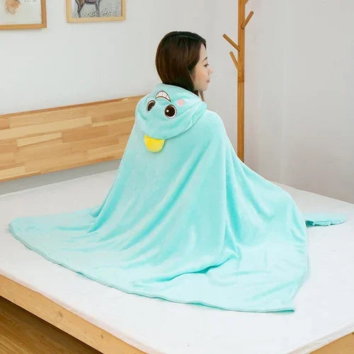 Person wrapped in a light blue kawaii cartoon character blanket on a bed.