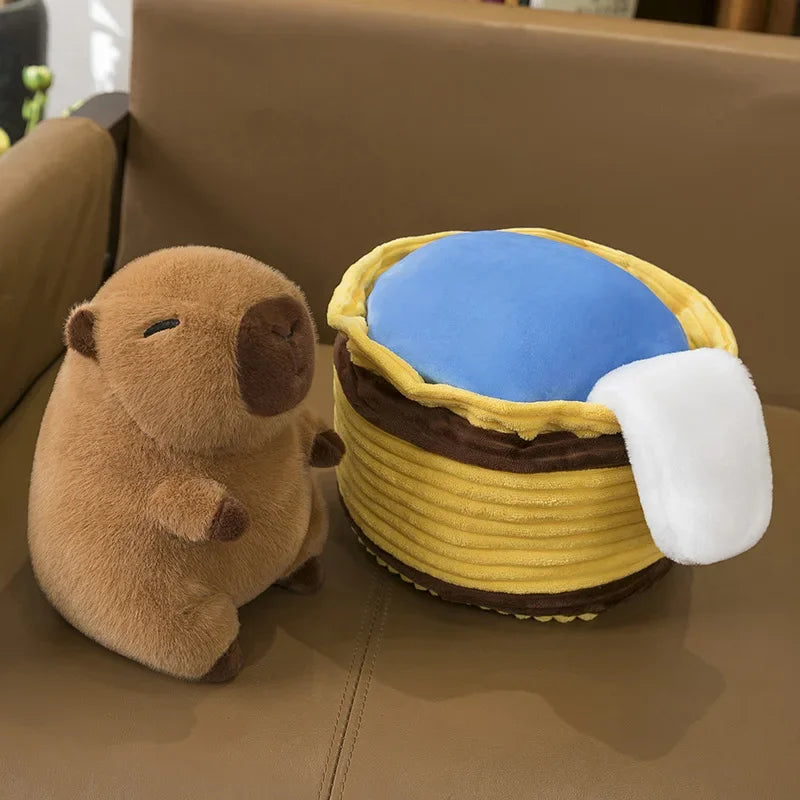 Kawaii plush toy beaver next to a plush toy honeycomb on a brown couch.