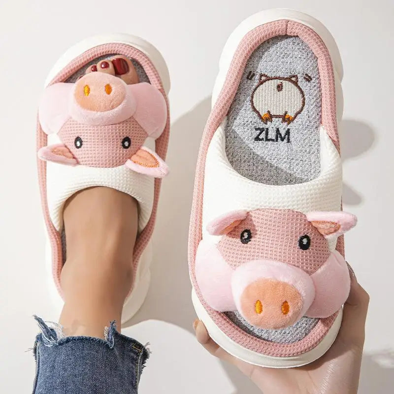 Pink pig-themed kawaii slippers with a visible brand logo on a light background