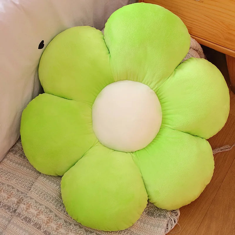 Flower-shaped green Kawaii cushion on a wooden floor