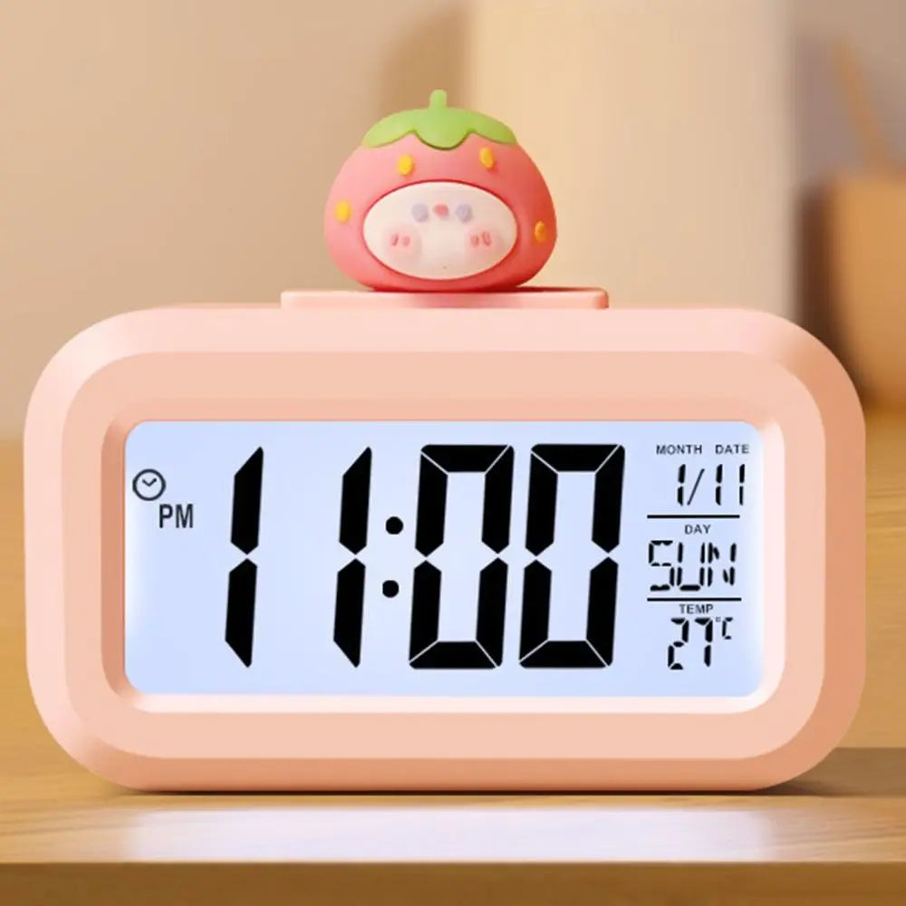 Kawaii digital clock with a strawberry-shaped decoration on top, displaying the time and date.