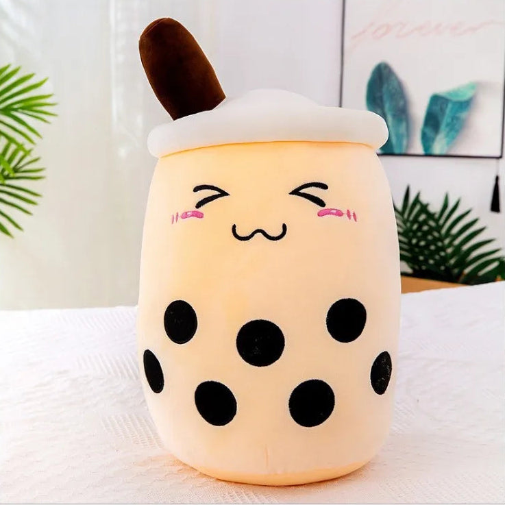 Plush kawaii toy shaped like a bubble tea cup with a face on a white surface.