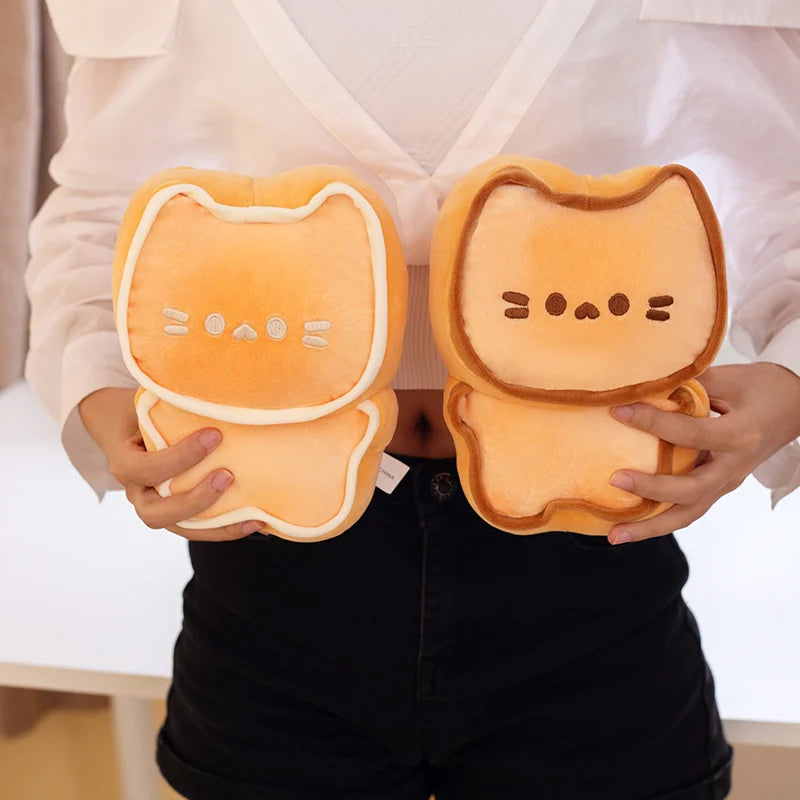 Person holding two cat-shaped toast plush kawaii toys