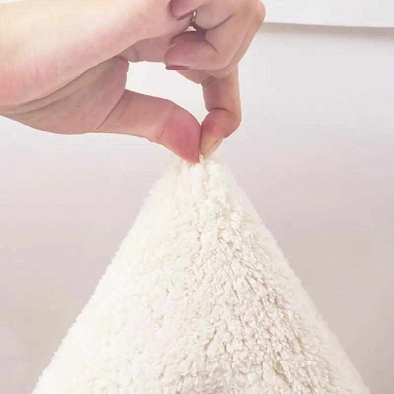 Close-up of a hand holding a small white fabric of a kawaii rug