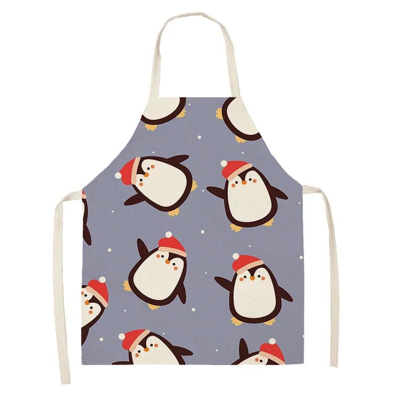 Apron with penguin Kawaii design wearing red hats on a blue background