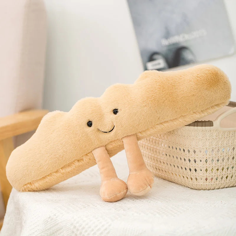 Plush kawaii toy shaped like a bread roll with a smiley face on a light surface.