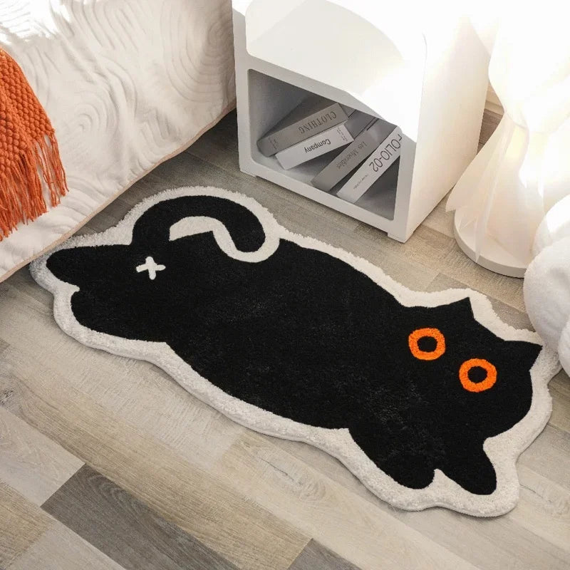 Black cat-shaped kawaii rug on a wooden floor with a white nightstand in the background.