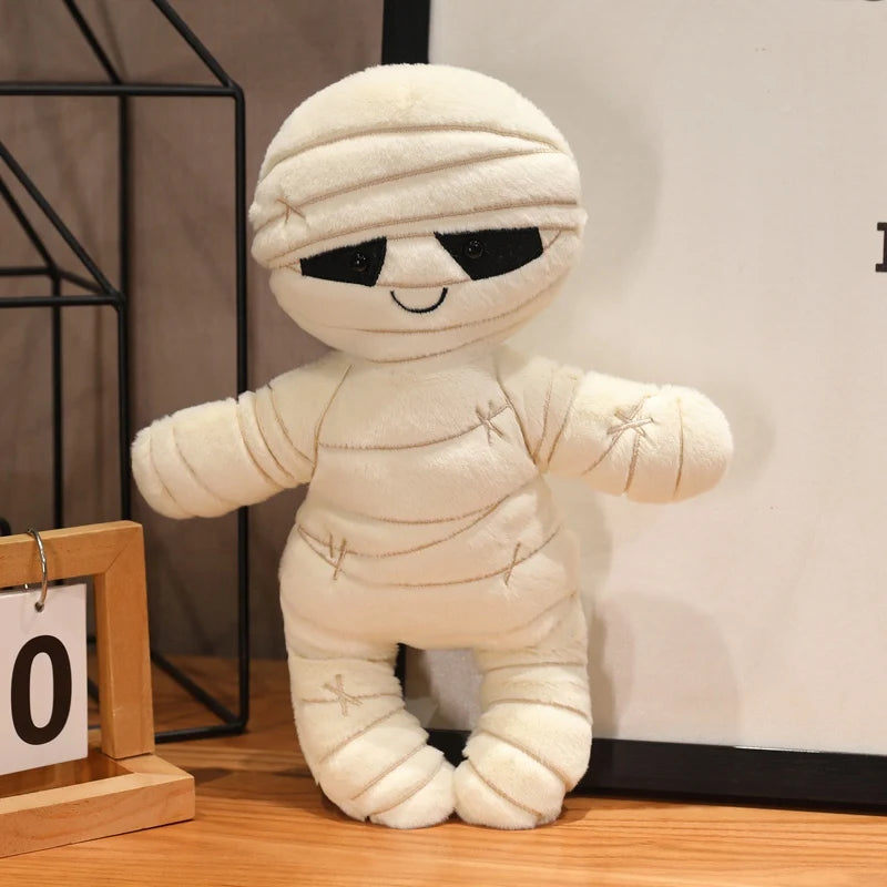 Plush kawaii toy mummy with black eyes on a wooden surface