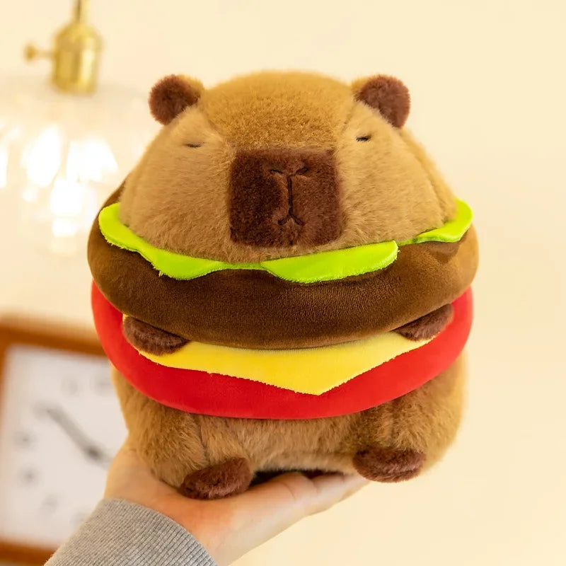 Kawaii plush toy shaped like a hamburger with a bear face held by a person.