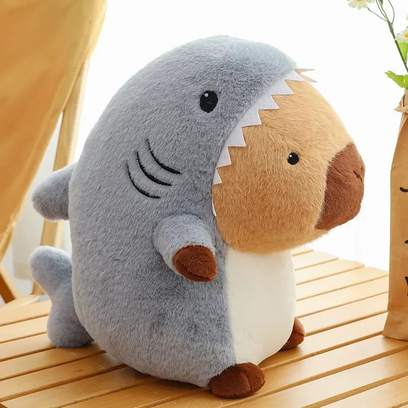 Kawaii plush toy shark with brown accents on a wooden surface