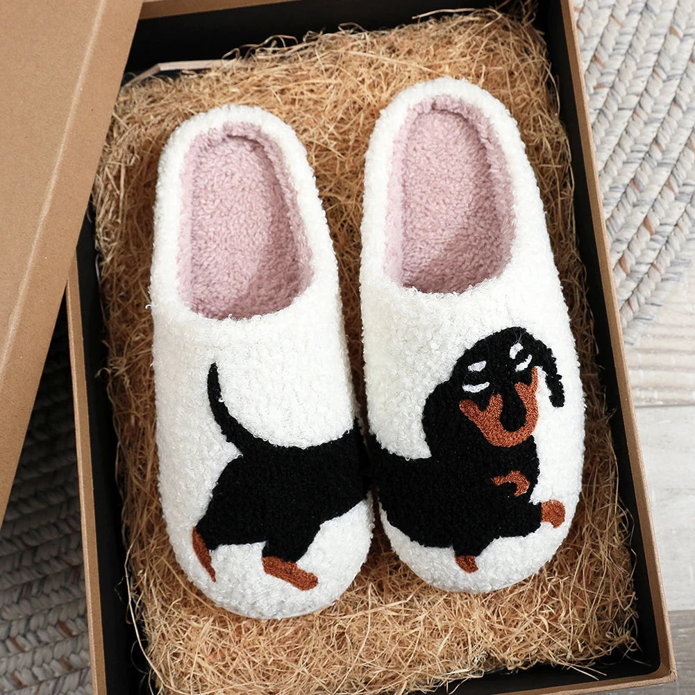 Pair of white kawaii slippers with dachshund design in a box filled with straw.